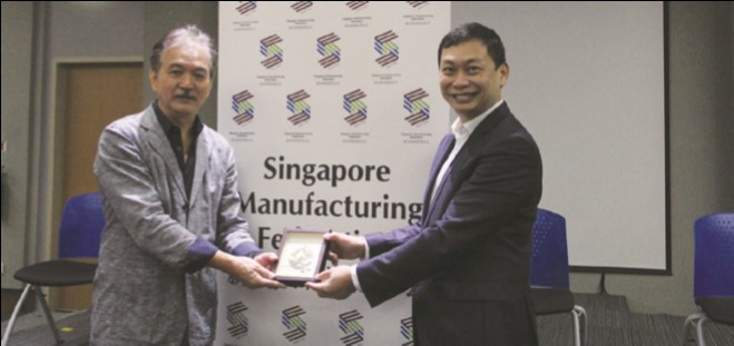 SMF President Mr Douglas Foo presenting a token of appreciation to Dr Robert Yap (left)