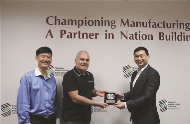 SMF President Mr Douglas Foo presenting a token of appreciation to Mr Leonard Musatov (middle) and Mr Edward Tay  (left) 